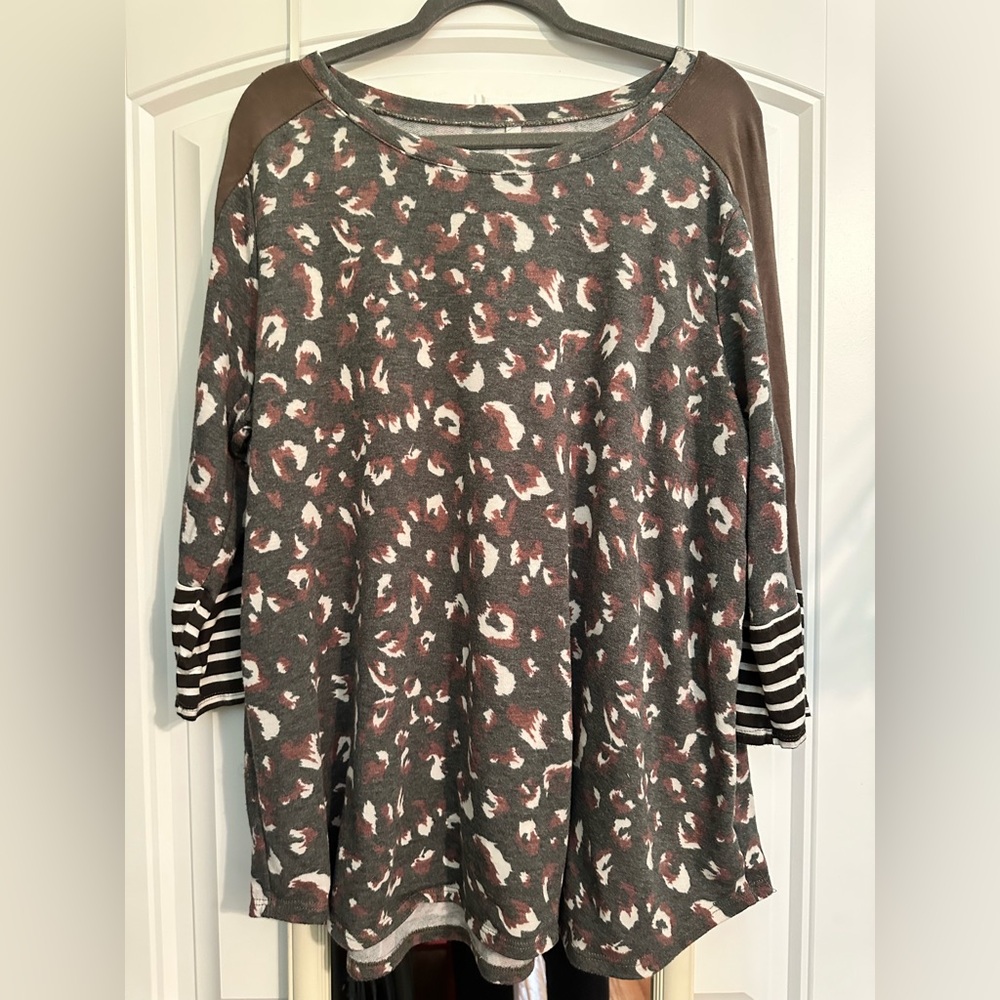 Size 2X Celeste Leopard Print 3/4 Sleeve Top w/non functional button on sleeve.